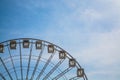 Big wheel against the background of the blue sky and an old city architecture Kiev, Ukraine. Amusement park. Area.