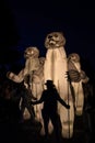 Big white artificial polar bear in the street at night