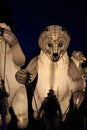 Big white artificial polar bears in the street at night