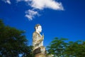 Big white Buddha statue raising high contrasting with blue cloudless sky at Wat Ek Phnom, near Battambang, Cambodia Royalty Free Stock Photo