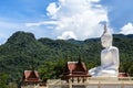 Big white buddha statue sitting on valley mountain