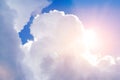 Big white cloud with sun and lens flare on bright blue sky Royalty Free Stock Photo
