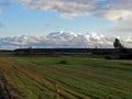 Big white clouds over the field Royalty Free Stock Photo