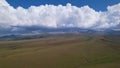 Big white clouds over green hills and mountains. Royalty Free Stock Photo