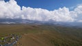 Big white clouds over green hills and mountains. Royalty Free Stock Photo