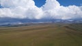 Big white clouds over green hills and mountains. Royalty Free Stock Photo