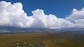 Big white clouds over green hills and mountains. Royalty Free Stock Photo