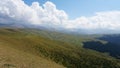 Big white clouds over green hills and mountains Royalty Free Stock Photo