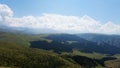 Big white clouds over green hills and mountains Royalty Free Stock Photo