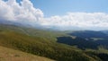 Big white clouds over green hills and mountains Royalty Free Stock Photo