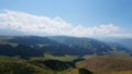 Big white clouds over green hills and mountains Royalty Free Stock Photo