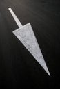 Big white diagonal arrow sign, painted on black asphalt road, road signage example. Royalty Free Stock Photo