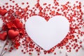 Big white heart around tiny scattered red confetti hearts.Valentine\'s Day banner with space for your own content. White back Royalty Free Stock Photo