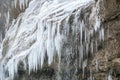 big white icicles of beautiful frozen waterfall. Beautiful winter landscape.