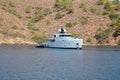 Big white modern yacht moored in Aegean sea near Turkey coast. Luxury white boat yacht against of the resort city. Ships Royalty Free Stock Photo