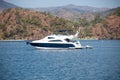 Big white modern yacht moored in Aegean sea near Turkey coast. Luxury white boat yacht against of the resort city. Ships