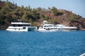 Big white modern yachts moored in Aegean sea near Turkey coast. Luxury white boat yacht against of the resort city Royalty Free Stock Photo