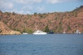 Big white modern yachts moored in Aegean sea near Turkey coast. Luxury white boat yacht against of the resort city Royalty Free Stock Photo