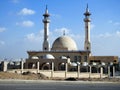 Big white Muslim mosque in Egypt on cloudy sky background, oriental Islamic architecture with minarets and domes Royalty Free Stock Photo