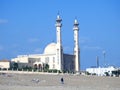 Big white Muslim mosque in Egypt on cloudy sky background, oriental Islamic architecture with minarets and domes Royalty Free Stock Photo