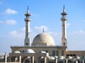 Big white Muslim mosque in Egypt on cloudy sky background, oriental Islamic architecture with minarets and domes Royalty Free Stock Photo