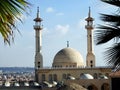 Big white Muslim mosque in Egypt on cloudy sky background, oriental Islamic architecture with minarets and domes Royalty Free Stock Photo