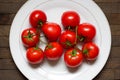 Big white plate with red washed tomatoes on it Royalty Free Stock Photo