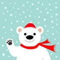 Big white polar bear in santa claus hat and scarf, waving hand paw. Royalty Free Stock Photo