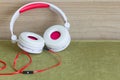 A big white and red headphones with modern background. Royalty Free Stock Photo