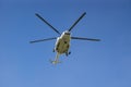 Big white Russian helicopter flying in the blue sky Royalty Free Stock Photo