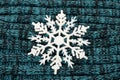 Big white snowflake on knitted wool background. Royalty Free Stock Photo