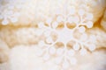 Big white snowflake on white knitted scarf background. Royalty Free Stock Photo
