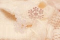 Big white snowflake on white knitted scarf background. Royalty Free Stock Photo
