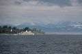 Big white touristic ship in a big lake surrounded with mountains