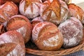 Big wicker basket ful of fresh baked homemade loafs of bread at the market for sale Royalty Free Stock Photo