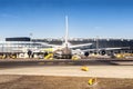 Big wide-body commercial passenger plane during maintenance and flight preparation at international airport. Service