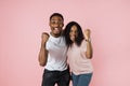 Big win. Happy excited african couple celebrating success with raised fists. Royalty Free Stock Photo