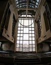 Big window in the main hall of a dilapidated abandoned hotel Royalty Free Stock Photo