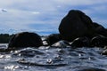 Big windy waves splashing over rocks. Wave splash in the lake against beach. Waves breaking on a stony beach, forming a spray. Wat Royalty Free Stock Photo