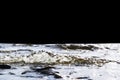 Big windy waves splashing over rocks. Wave splash in the lake on black background. Waves breaking on a stony beach, forming a spra Royalty Free Stock Photo