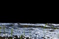 Big windy waves splashing over rocks. Wave splash in the lake isolated on black background. Waves breaking on a stony beach Royalty Free Stock Photo