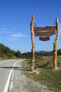 Big wood sign by the road on the mountain