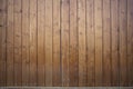 Big wooden barn gate. Monumental farm door, two timber leaf, closed brown gateway with planks and nails