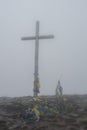 Big wooden cross covered with flags of Ukraine Royalty Free Stock Photo