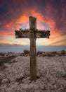 Big wooden cross at the seaside while coloful sunset