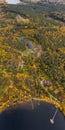 The big wooden house in forest, Drone view point of rural area in Autumn with lake Boroye, Piers on the lake, Valdai Royalty Free Stock Photo