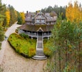 The big wooden house in forest, Drone view point of rural area in Autumn with lake Boroye, Valday national park, Russia Royalty Free Stock Photo