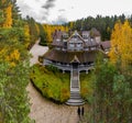 The big wooden house in forest, Drone view point of rural area in Autumn with lake Boroye, Valday national park, Russia Royalty Free Stock Photo