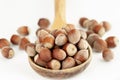 Big wooden spoon with great bunch of hazelnuts isolated on white background Royalty Free Stock Photo
