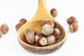 Big wooden spoon with little bunch of hazelnuts isolated on white background Royalty Free Stock Photo